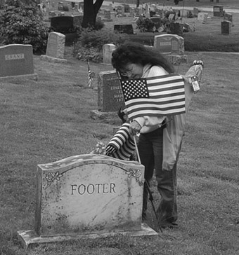 May 2012 Mbr Lyni McCreary placing flags on the graves of lodge members passed on.