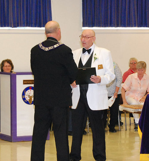 During Installation of Lodge Officers for FY 2014-15, outgoing (2nd time) ER Gerry Wyman recognizes Trustee Chuck Billings as Officer of the Year.