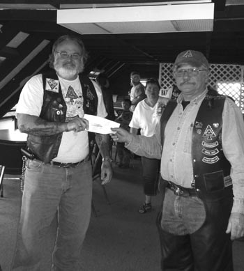 June 16th, 2012: United Bikers of Maine, Sagadahoc County Director Ernie DiBiasio presents $455, raised for the Main Children's Cancer Program, to Bath PER "Mac" McCreary.
The money was raised via the 12th annual June ride, called "Zane's Ride".