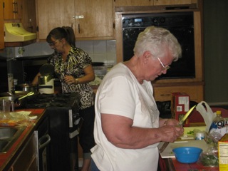 Earline Blankenship (foreground) and Nancy Hudson (background), preparing a scrumptious Pot Luck Entree.