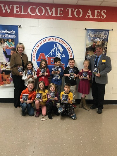 ER Steve Gregory and Suzanne Newswanger present dictionaries to students at the Apalachin Elementary School in support of the Elks Dictionary Project