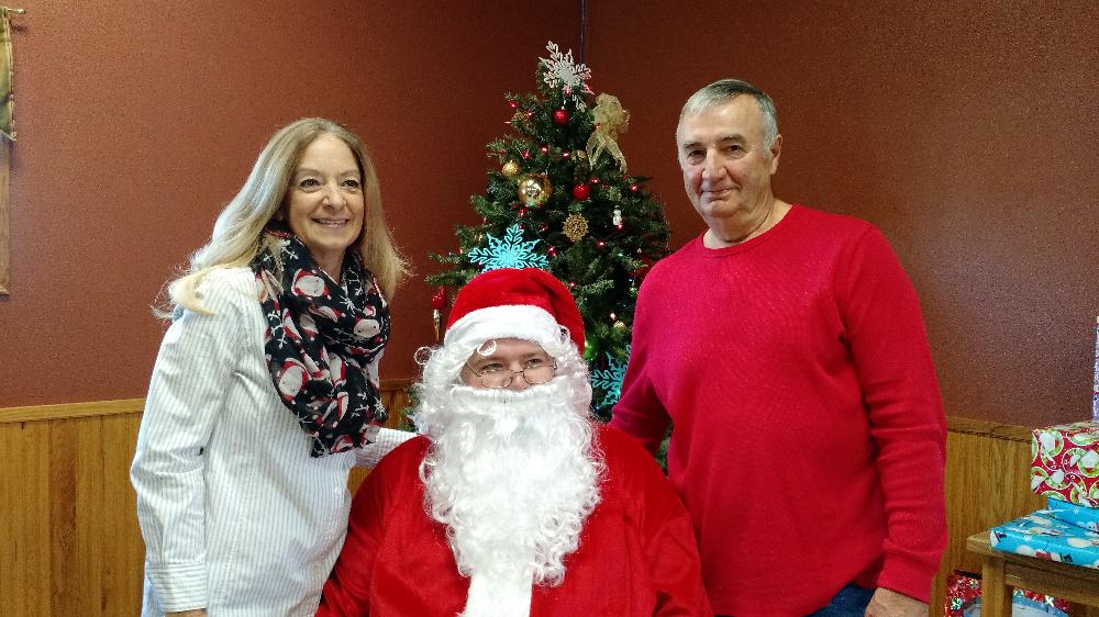 2017 Children's Christmas Party Jim and Angie G (Elves) with Santa (Dan R)
