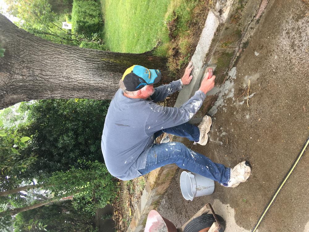 Elky-Doer, Trustee Jim Schlueter repairing the block wall on the path to the river trail. 