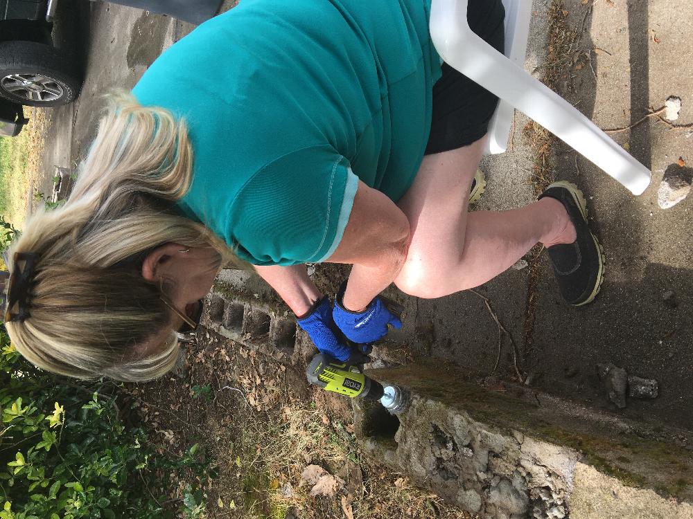 Elky-Doe Jodi Stone repairing the block wall on the path to the river trail. 