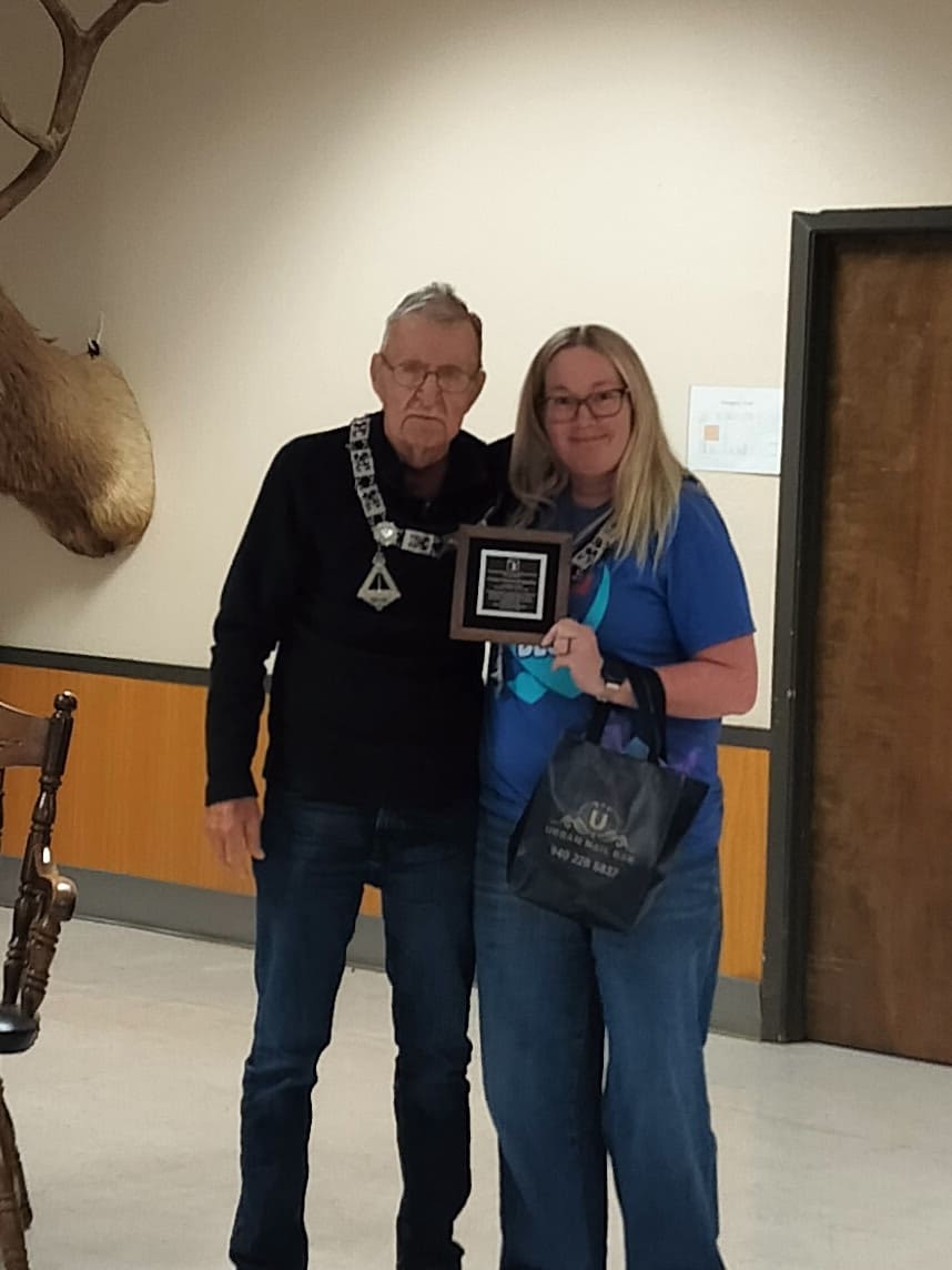 April 7, 2026: Esquire Don Pepper presents Past Exalted Ruler and five-year Trustee D’Anna Bergandino with a plaque recognizing her cumulative individual contributions of $5,000 to the Elks National Foundation.