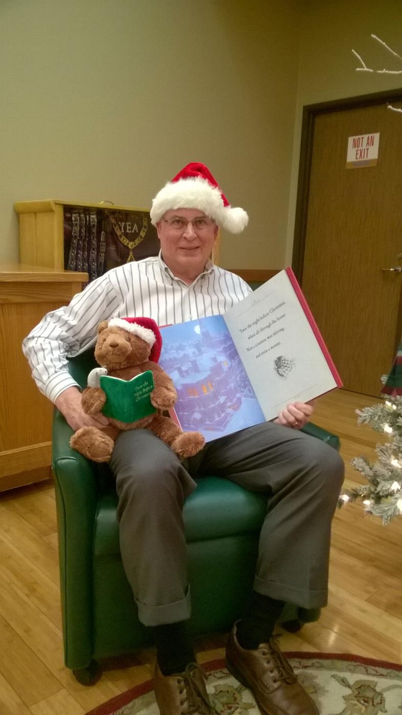 ER, Gary Lisignoli, prepared to share the Christmas Story with children at the Christmas party with his special story reading Bear