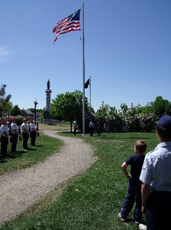The American Flag is raised from half staff during services on Memorial Day  at the Rochester Commons.