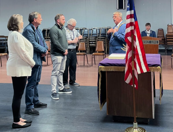 Three new Elks receive their pins on May 10, 2022, welcomed by Exalted Ruler Steve Scholz. From left: Leslie Fenske, Mark Fenske, and Kyle Lentz. 