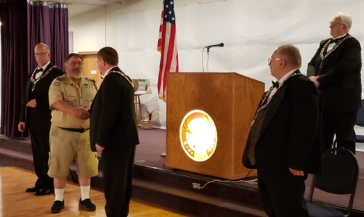 Lodge Esquire Rob Dahl (L), Chaplain Dave Ward (R) and Secretary John Fowler (Far R) look on as Exalted Ruler Dave Southwick presents a check for $100 to Scoutmaster Roger Mansur in appreciation for the Scouts participation and in support of their program. 