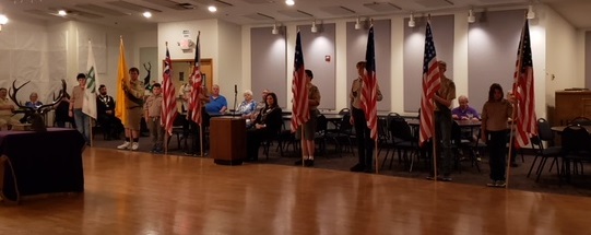 Scouts from Troop 695 present the various historical flags of our nation.