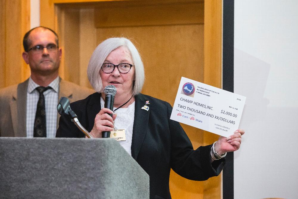 Lodge Chaplain Betsy Reney presenting a $2000 "check" to Champ Homes for the new freezer thanks to ENF Gratitude Grant.