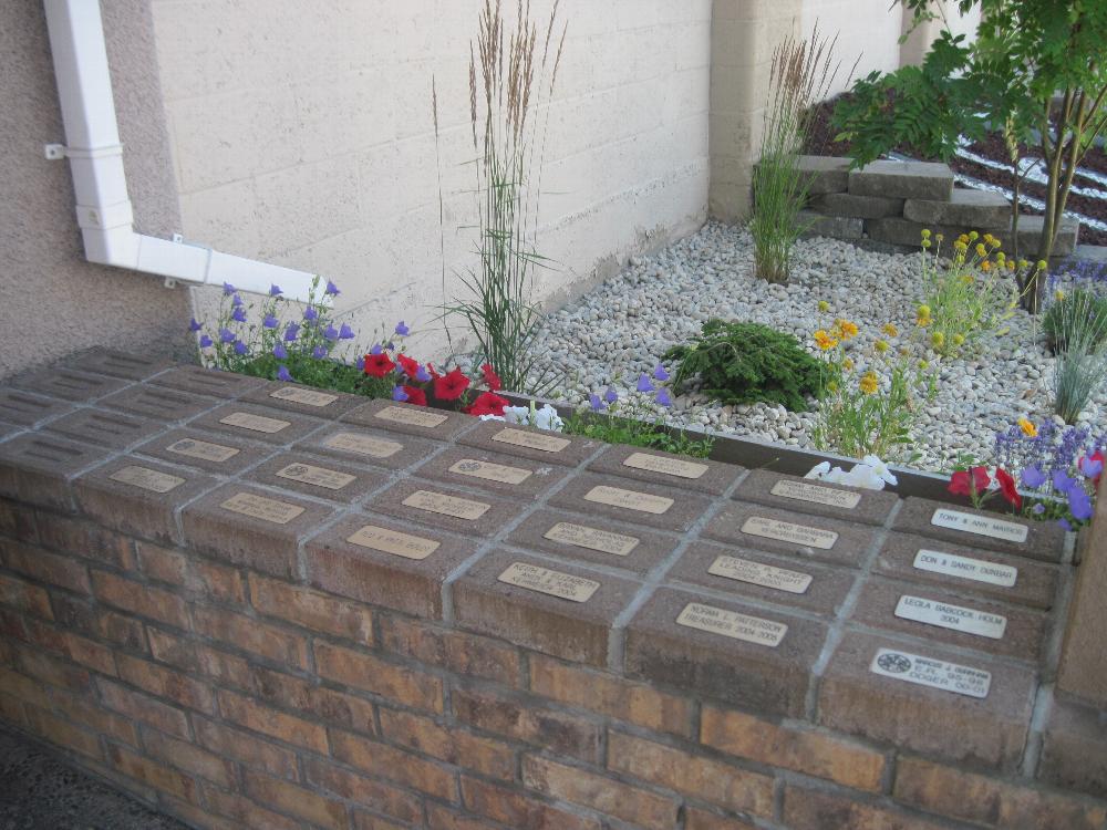 On both sides of our entry door are paver bricks purchased by members.  Bricks are purchased for wives, children or as a memorial to a loved one.