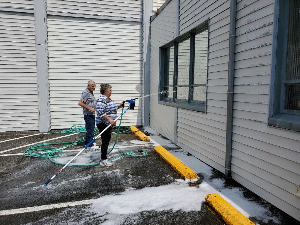 PER Larry & Trustee Marlene Gore washing the building.