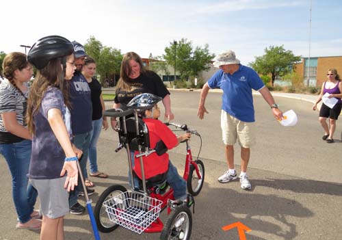 Lodge member Larry Martinez teaches course riders the proper hand signals to use while riding in traffic. Riders were also quizzed on safety issues throughout the course and given vouchers for popsicles at the end of the route. 