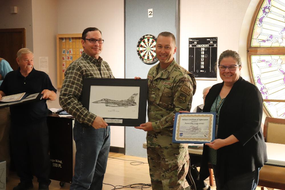 Lodge  VA Rep 
Dan Halkett accepting a lithograph fron the Colorado Air National Guard Rep 1stSGT Lucas Vanderwerff.