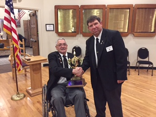 Lecturing Knight Richard Guerrero accepts the Traveling League bowling trophy from Exalted Ruler Bob Charleston.