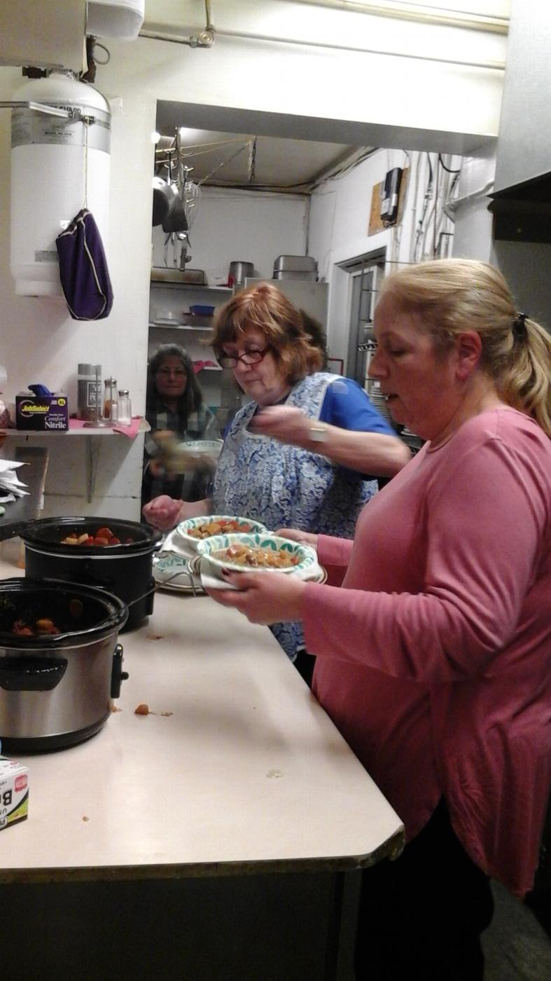 Exalted Ruler Becky Whelan and Chaplain Christa Donn dish up dinner for their guests.