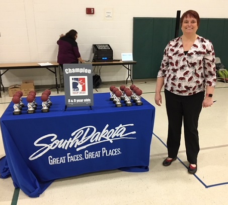 Heather Perry organizes the Pierre Hoop Shoot.  She's shown here standing with trophies the that were handed out to the top participants in the 2018 competition.