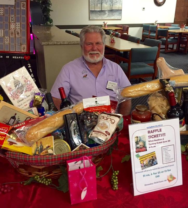 Lecturing Knight Jerry French and one of the raffle baskets.