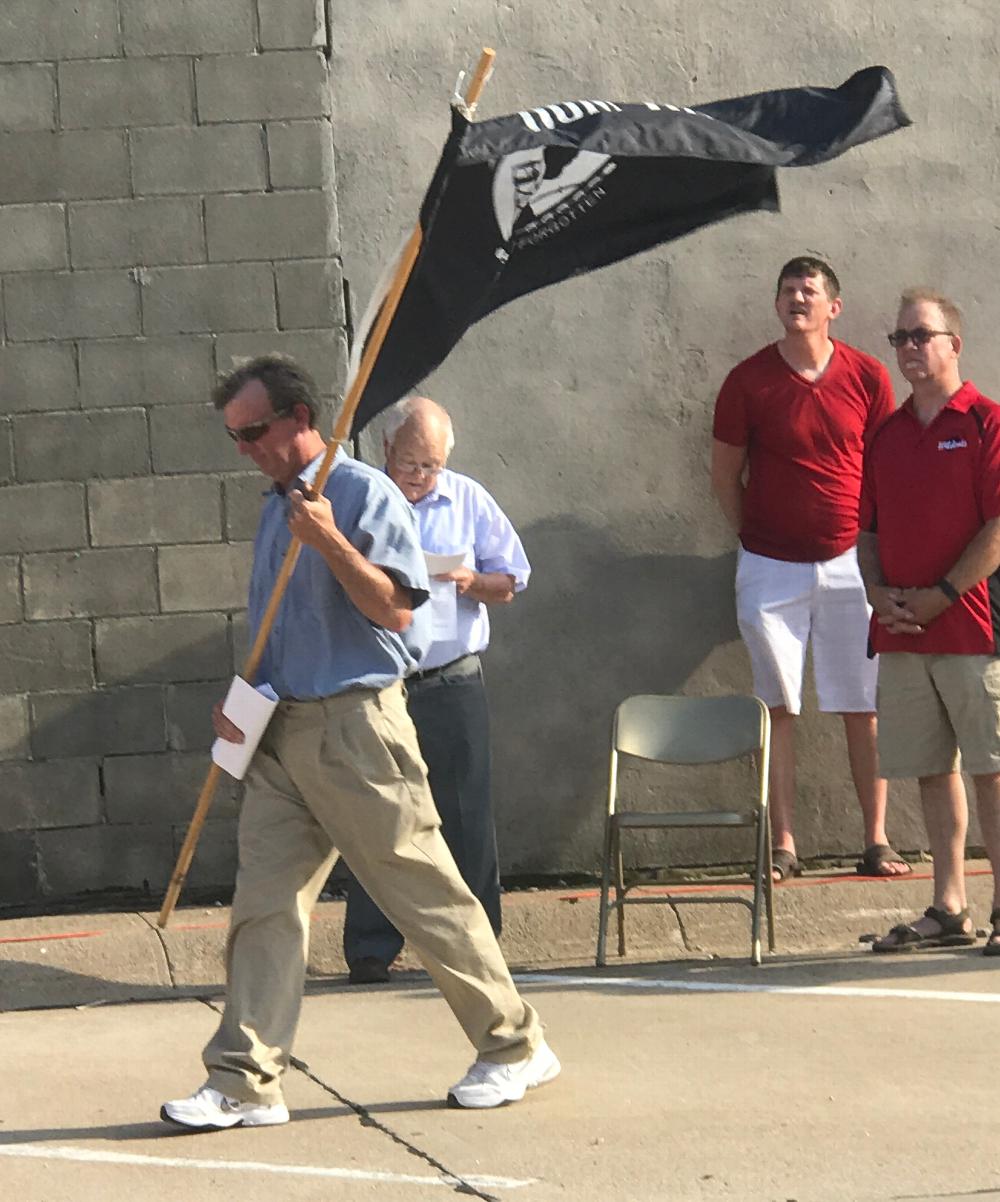 Past Exulted Ruler and current Esquire Larry Langer carries a flag during the ceremony