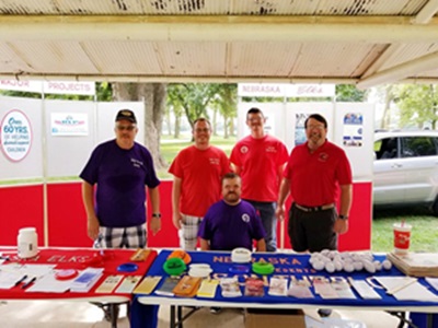 Elks members Rod Deuel, Austin Karnatz, Craten McKee and Brian Splater man the booth at the Touch A Truck event held in Superior