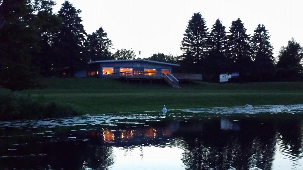 Lakeside view of lodge at dusk.