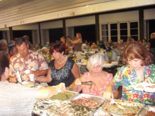 Members enjoy the chow line at our annual Luau fund raiser