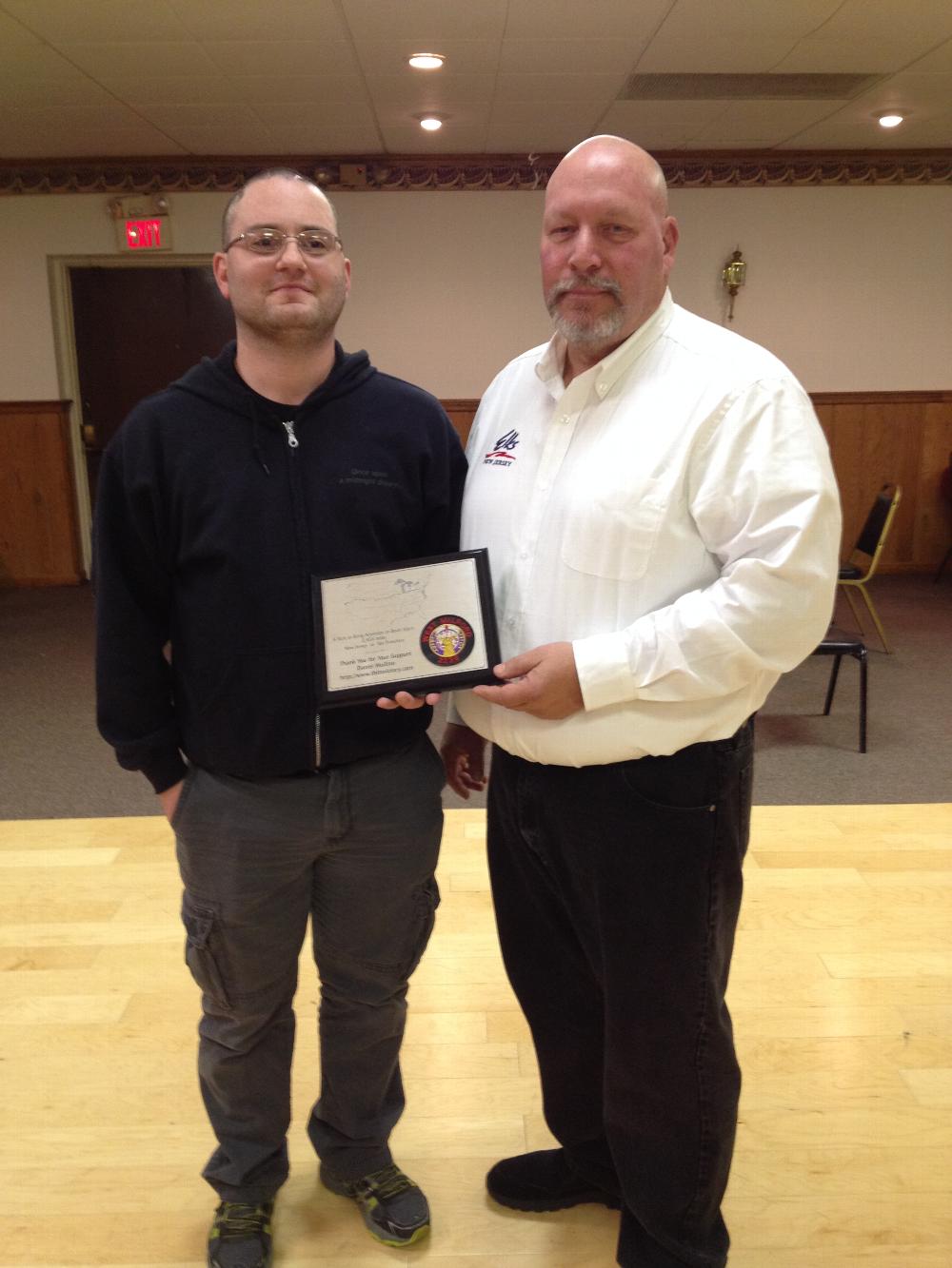 Plaque presented to WM Elks' ER Otis Asmus from member Daniel Mollino who trekked crossed the country for awareness of Traumatic Brain Injury.