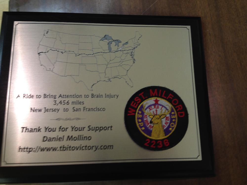 Plaque presented to WM Elks' ER Otis Asmus from member Daniel Mollino who trekked crossed the country for awareness of Traumatic Brain Injury.