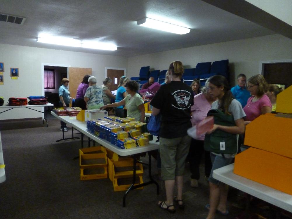 Volunteers stuffing backpacks