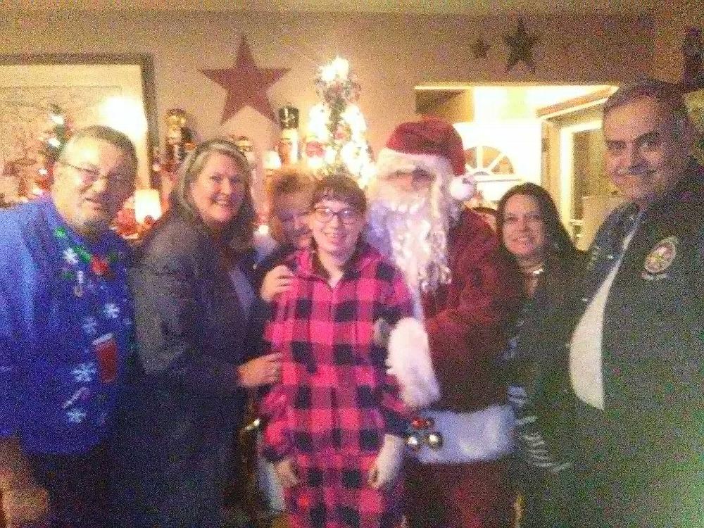 Officers from Colonia & Woodbridge Elks with Sharon and Santa after we delivered her presents.