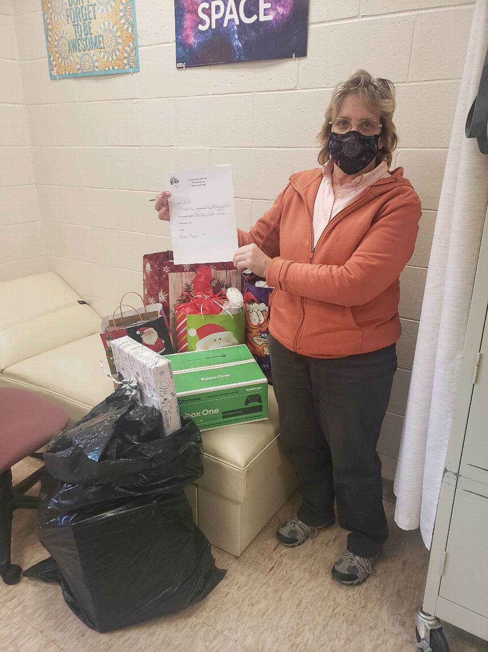 The nurse at the Great Meadows Middle School with some of the donations the Lodge donated to the children in its Title 1 program. The purchases were funded by the Beacon grant.