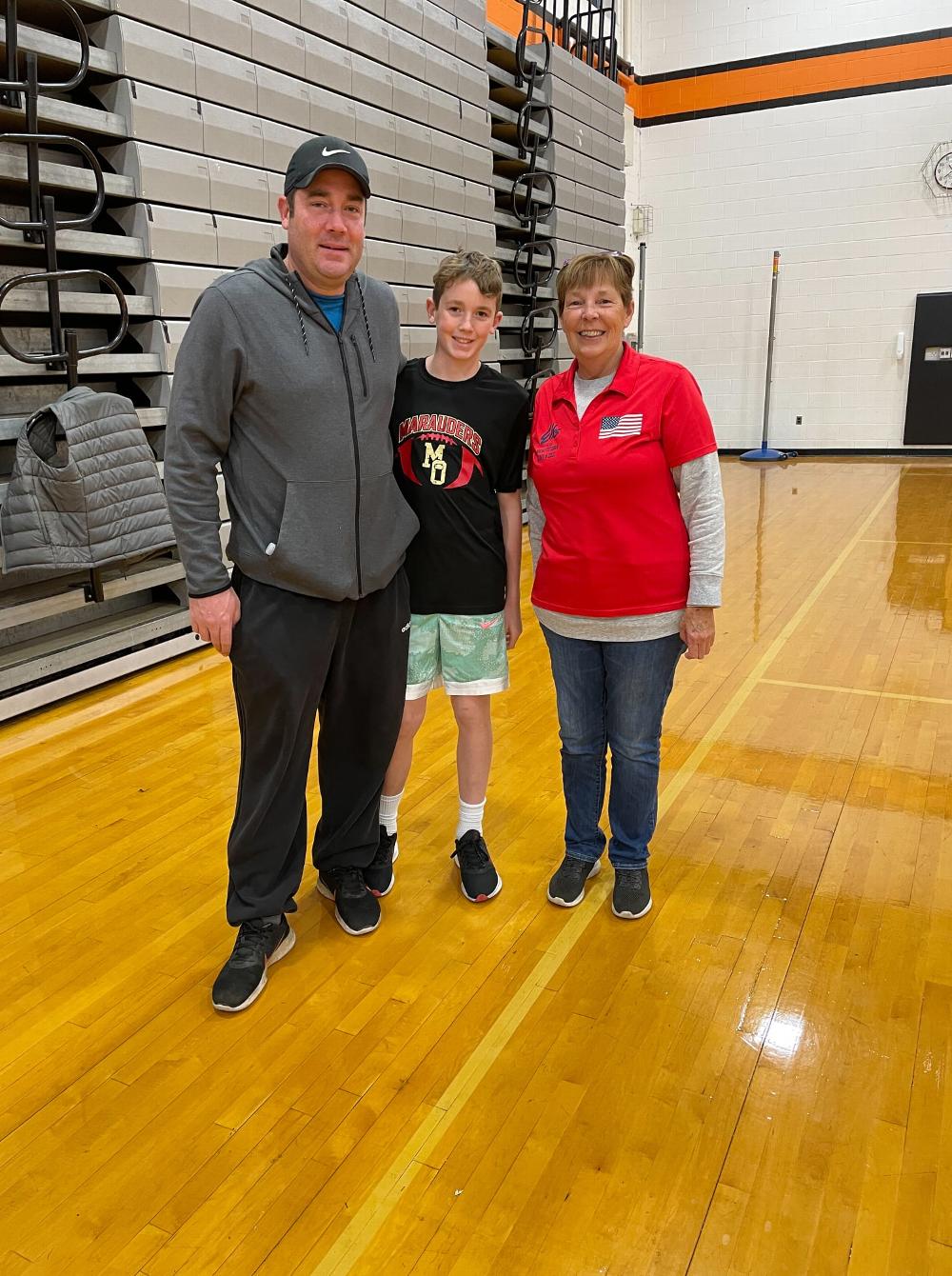 Member, Helene Walsh, with a dad and his son who participated in our Hoop Shoot.
