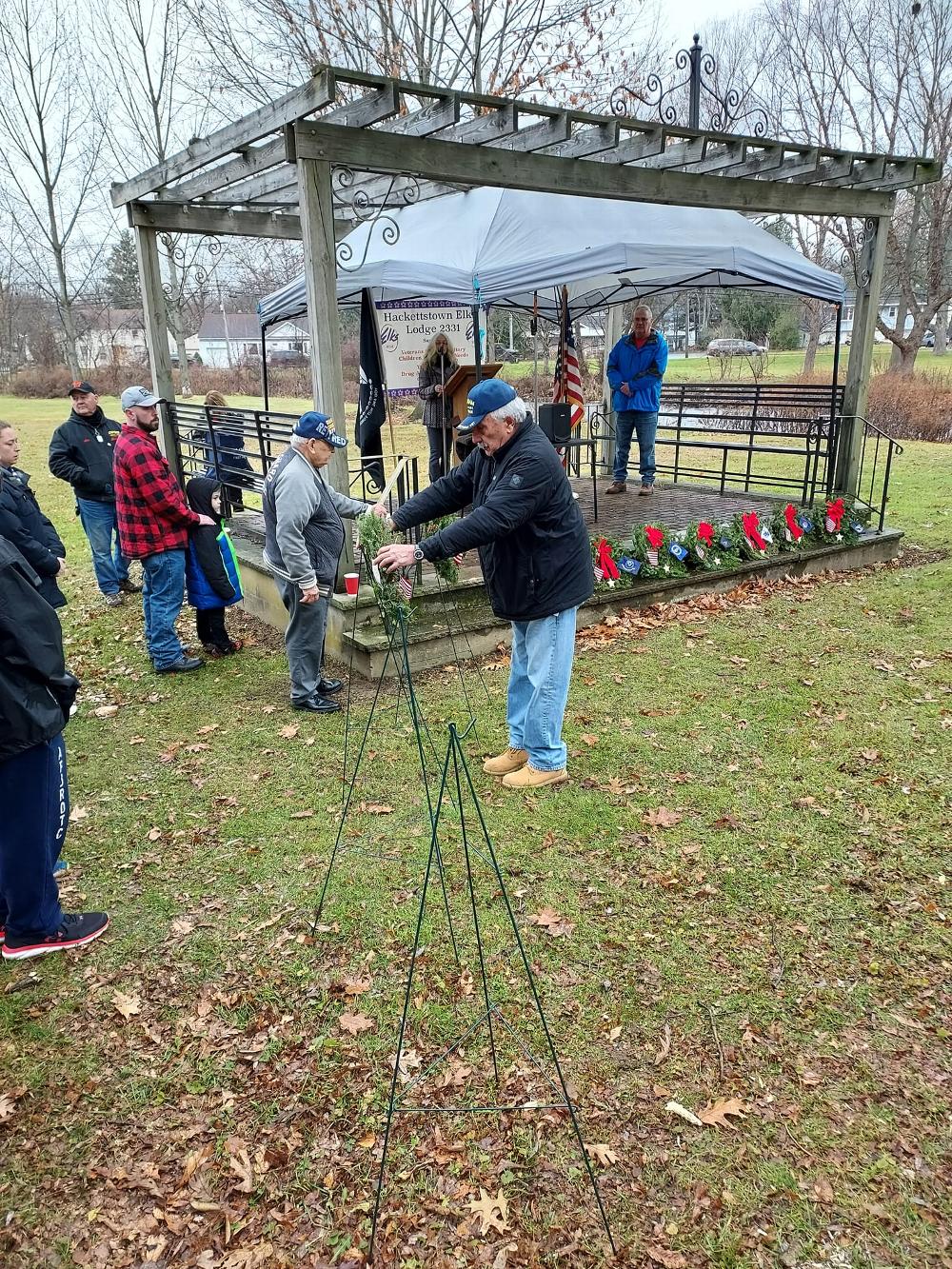 A veteran places a wreath to honor veterans at the Wreaths Across America ceremony held at the Union Cemetery.