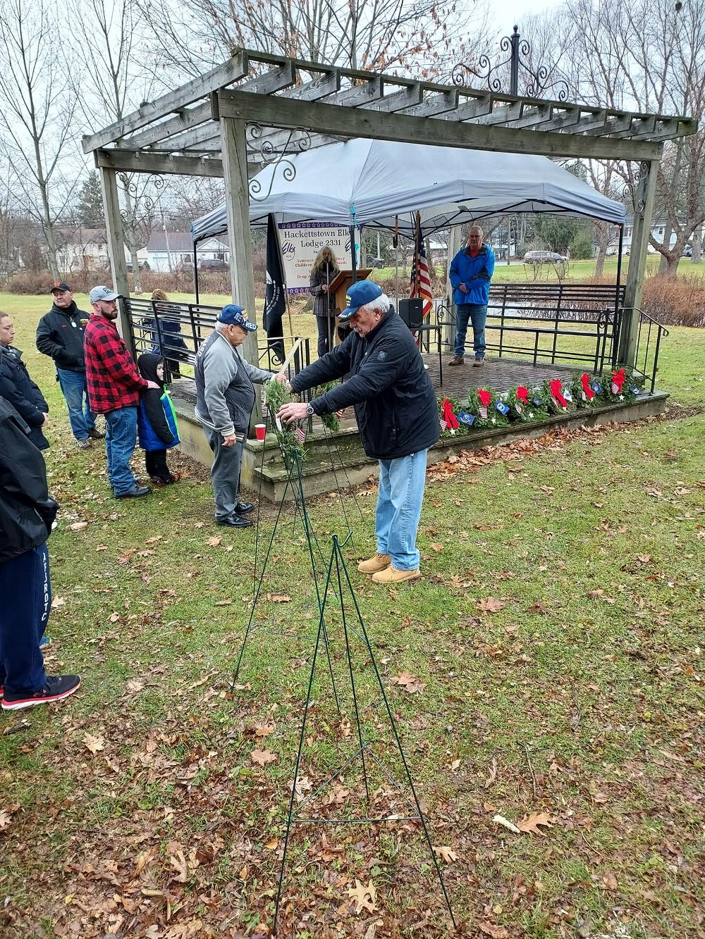 A veteran places a wreath to honor veterans at the Wreaths Across America ceremony held at the Union Cemetery.