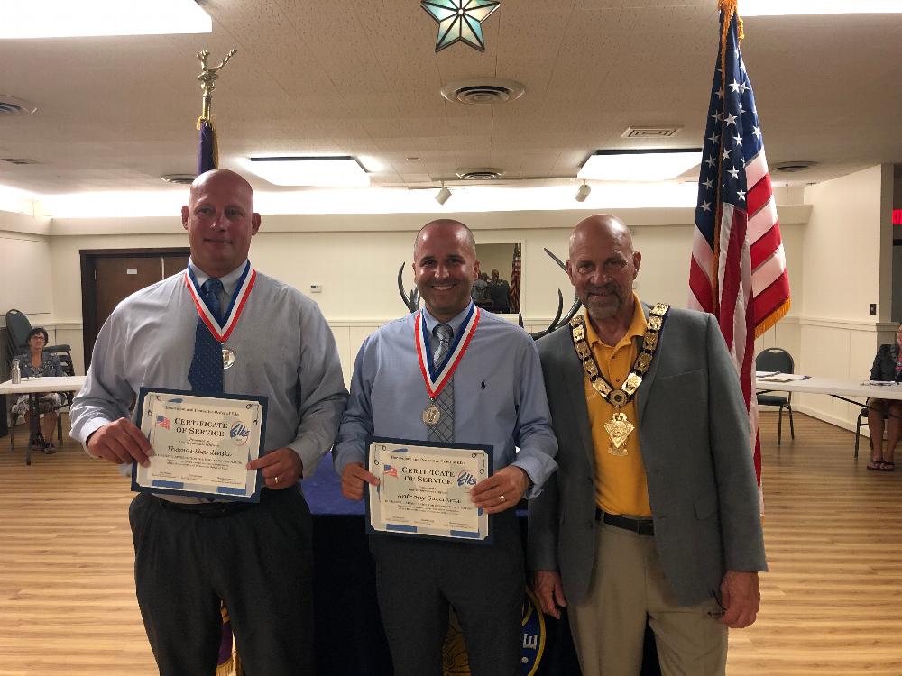 Camillus Elks Lodge 2367 recognized many individuals from the community at the lodge meeting. Officer Thomas Skardinski and Detective Anthony Gucciardi of the Camillus Police Department  along with Exalted Ruler Jay Mason received medals for their service giving back to the community along with a Certificate of Service and an American Flag pin. 
