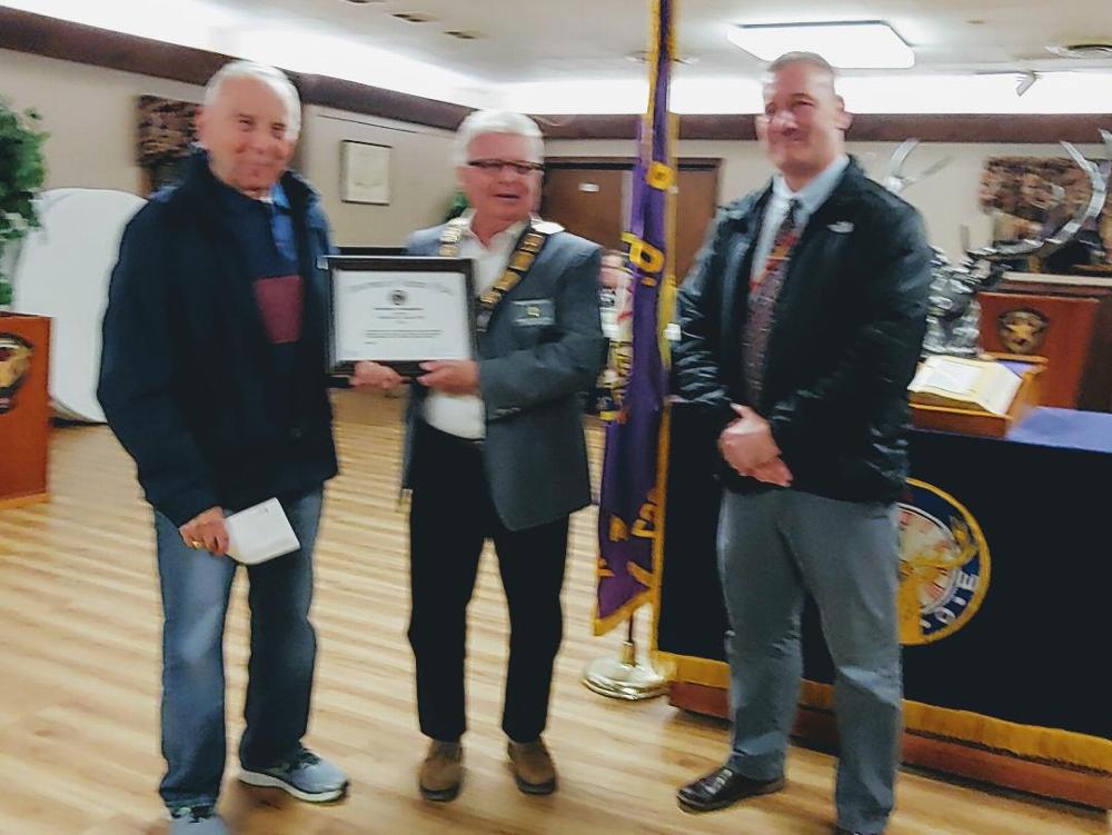 Dennis Fogg (right) Director of Volunteer Services at The Syracuse Veterans Administration Hospital presents a Certificate of Appreciation to Camillus Elks Lodge ER Jim Roe (center) and Lodge Veterans Affairs Director Bob Mario for the support our Lodge provides to enhance the comfort of th hospital's residents. (10/25/19)