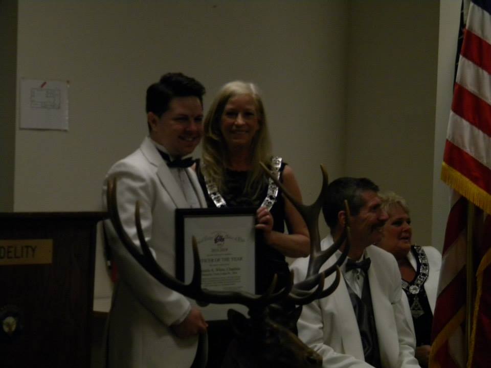 Pam White receives "Officer of the Year" award from 2013-2014 ER Chris Pool.  Congratulations Pam.  We know the number of hours you volunteered always with a smile!