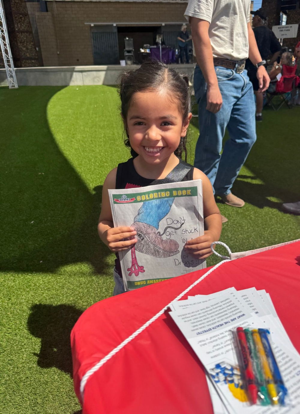 A little visitor to our booth to get an awesome coloring book from Sarah and Team!