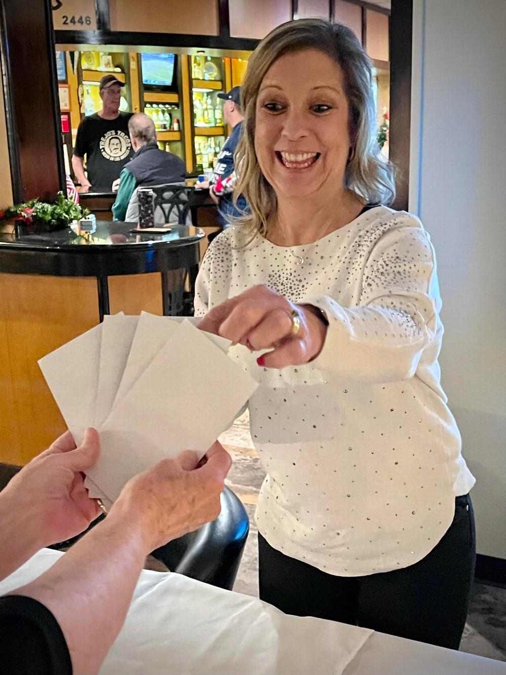 Esteemed Leading Knight Elizabeth Nugent gets her choice of prize envelopes at the Denton Lady Elks Member Appreciation Dinner 