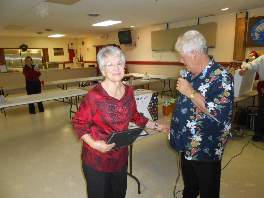 Billie York is recognized for her service to the Lodge with a presentation from Charlie Davis.