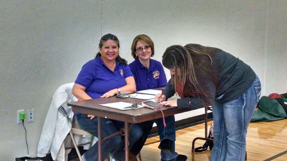 Jan Warwick and Annette Lujan help with registration