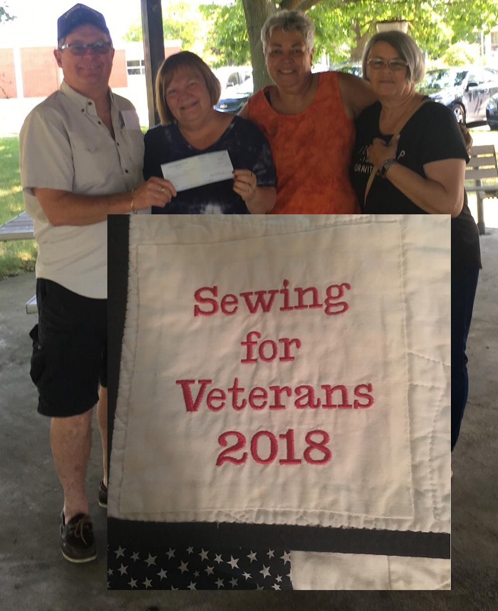 Larry Ohlsson, Veterans Commission Chairman presents a check to Cindy Jater a member of Sewing For Veterans's who make quilts for the local veterans.