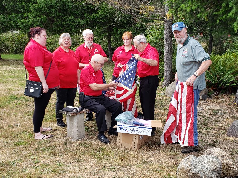 Officers and members observing and participating in annual flag burning.