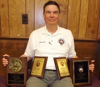Past Exalted Ruler Mike Lange displays four awards won by the Skowhegan-Madison Lodge at the state convention on May 4, 2013: Best Lodge Bulletin (Central District), Highest Per-Capita ENF Contributions (751-1,000 members), Best Public Relations Program (Central District) and Maroon Nemer State Chairman of the Year.