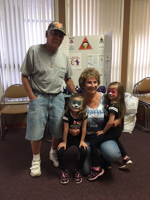 Joe Pinczes PER with Carol and their twin great grand daughters. The twins got their faces painted at the Family, Food, Fun Day