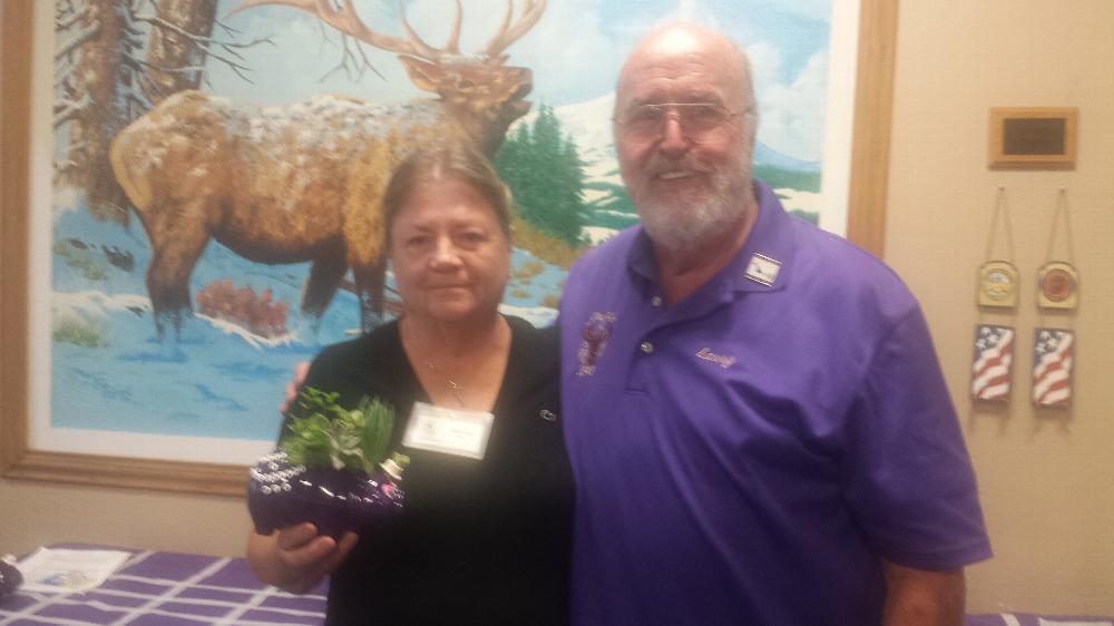 Margaret Yorio with her Purple Pig decoration next to Larry Fink.