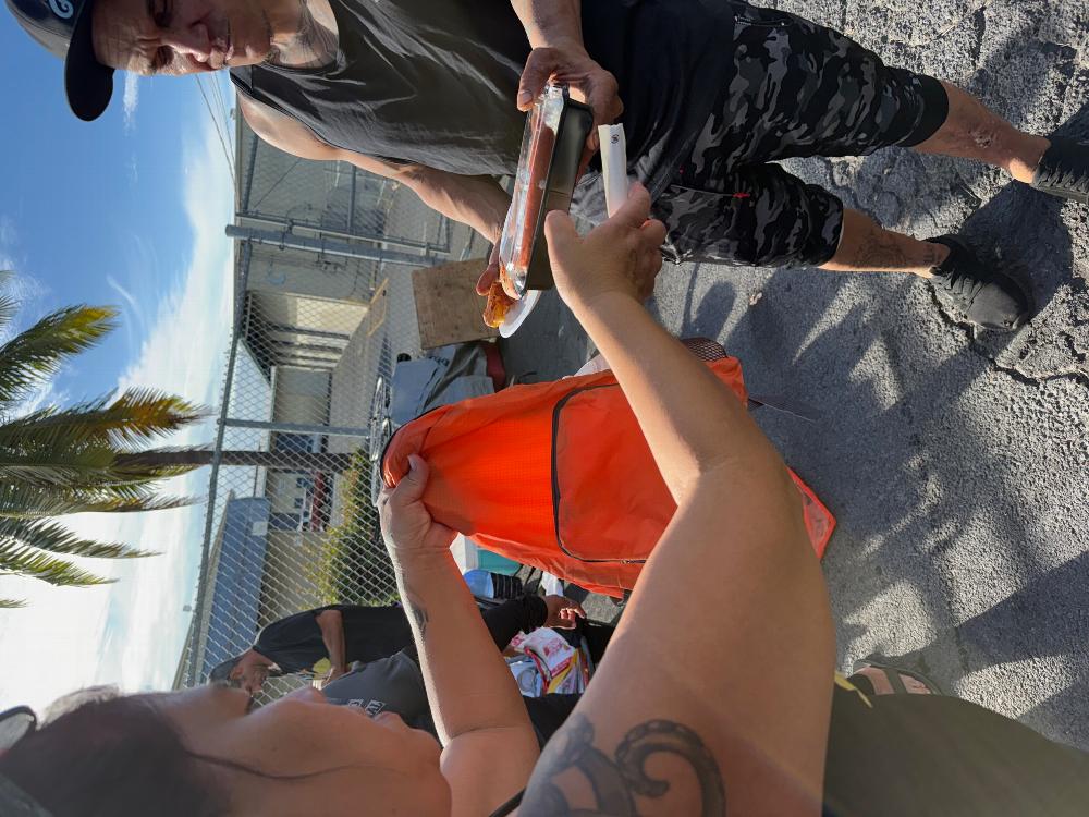 Handing a Bento and Backpack to a man to hand to a veteran that was unable to walk and receive it on his own. The veteran said "everyone is one paycheck, one problem or one step away from being on the streets" that hit me so hard I came to tears. 