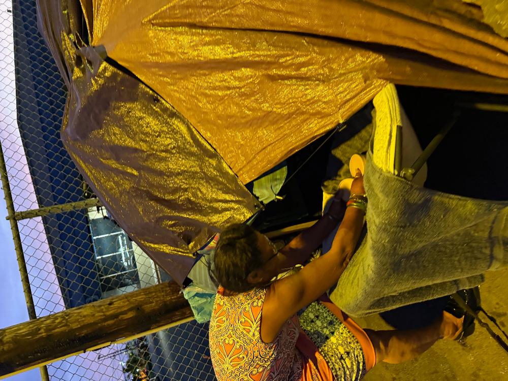 Feeding a homeless couple . She got laid off of her job she worked for so many years. He wouldnt come out of the tent