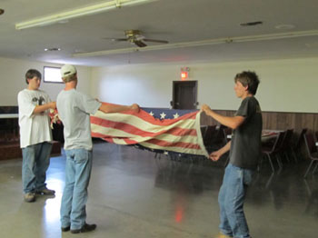 The Scouts folding the flags into the traditional 7 fold triangle prior to the Ceremony